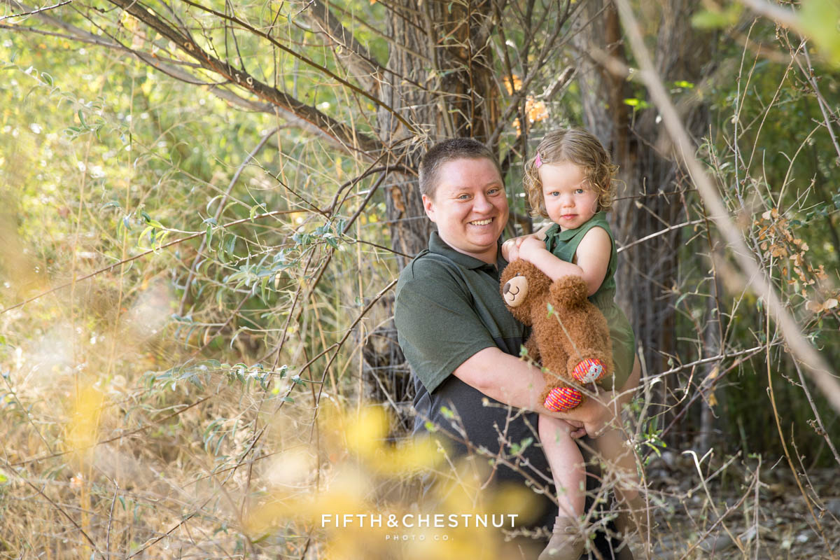Mother and daughter next to a fall tree at the Oxbow Nature Study in Reno