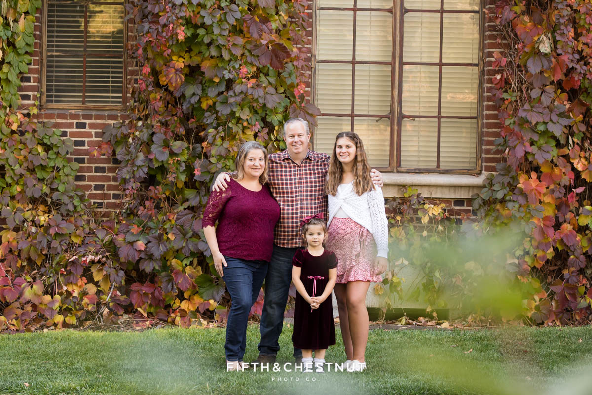family standing in front of colorful ivy wall at UNR for family photos