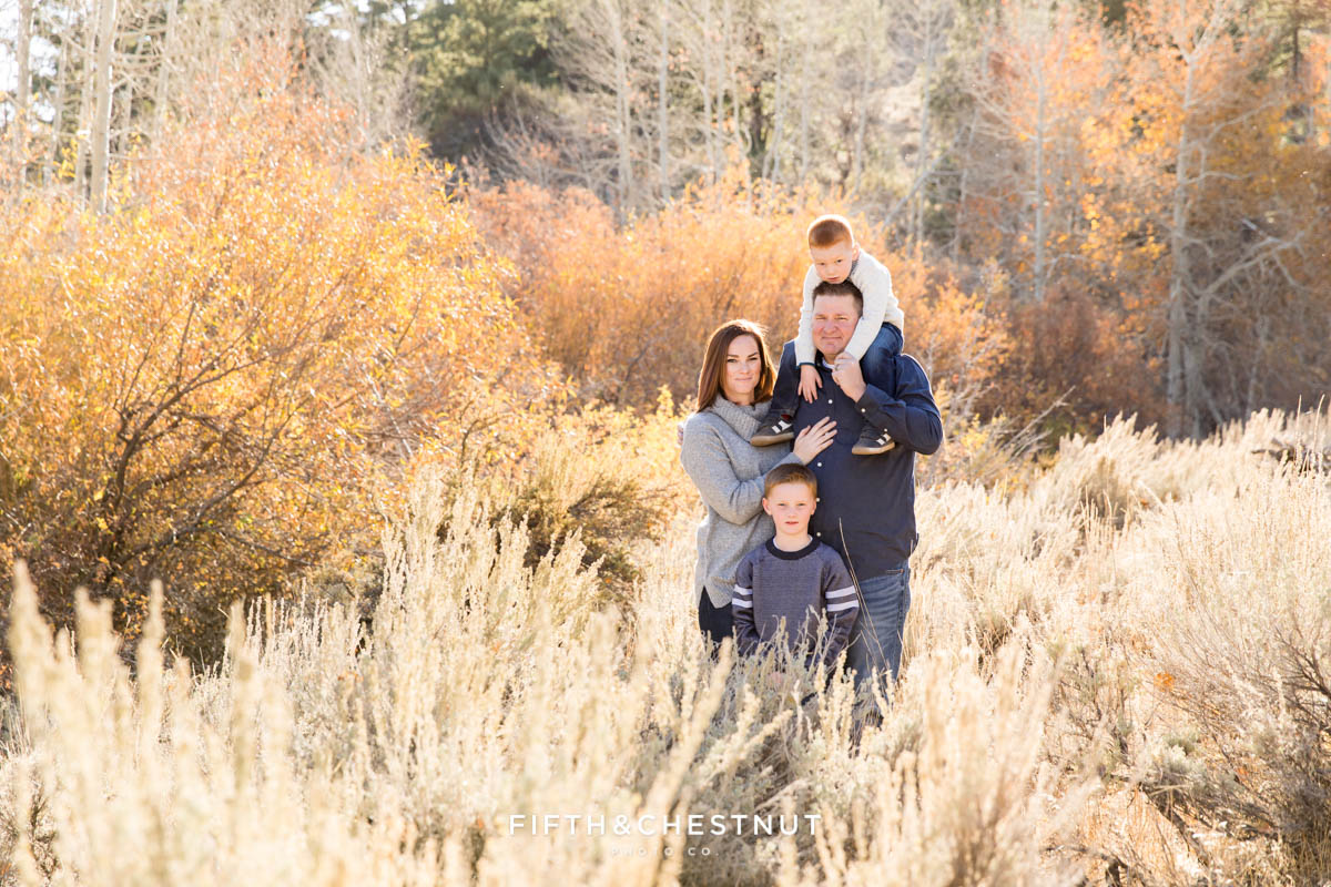 A family is backlit by the sun for Thomas Creek Portraits on a beautiful fall day.