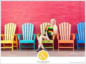 Downtown Reno Teen Portrait - young woman modeling on chairs in front of red building