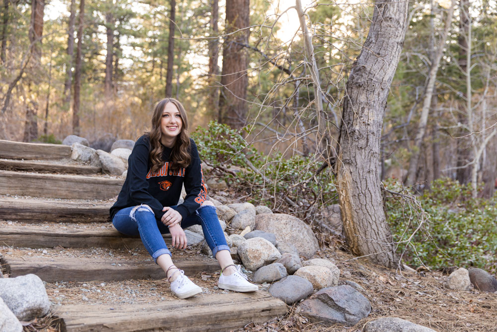 A reno high school senior sits on steps at Galena Creek Park for her reno high school senior portraits