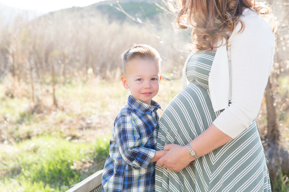 Little boy poses with mommy and her pregnany belly for Reno Family and Maternity photo by Reno Maternity Photographer