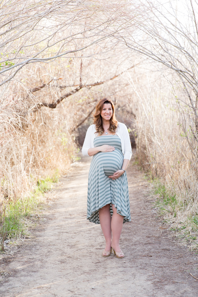 Lovely mama-to-be showing off her pregnant belly at the Oxbow Nature Study in Reno for Reno Family and Maternity photo by Reno Maternity Photographer