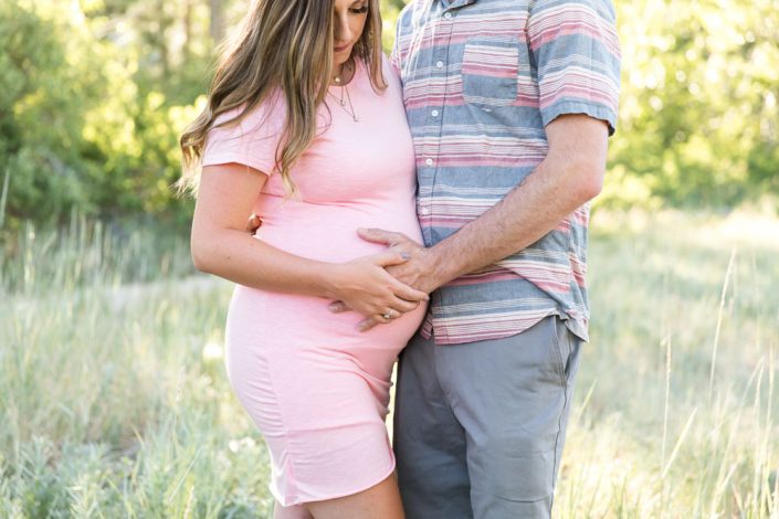 Husband and wife dream of their baby girl in a beautiful lush location for reno maternity photos with Reno Maternity Photographer