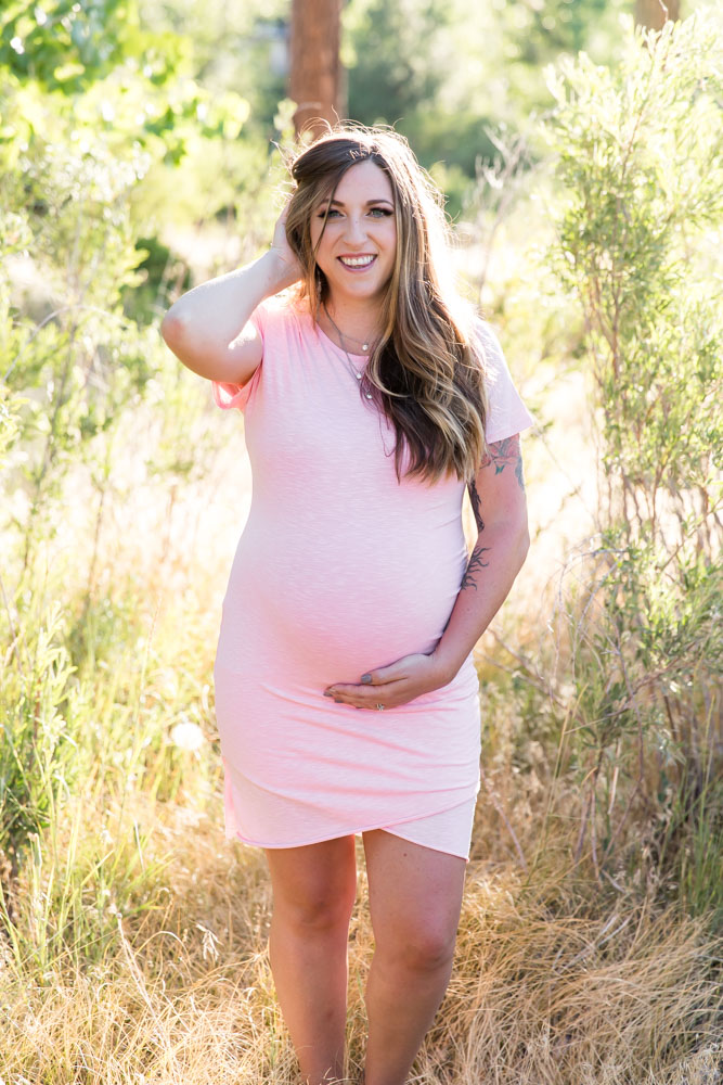 gorgeous pregnant woman in a pink dress for Reno maternity portraits by Reno maternity photographer in the summer