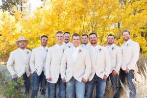 Groomsmen laugh in front of yellow aspen trees for a Fall wedding at Galena Creek Fish Hatchery by Reno Wedding Photographer