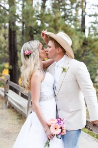 Bride lifts groom's hat to give him a kiss for a Fall wedding at Galena Creek Fish Hatchery by Reno Wedding Photographer