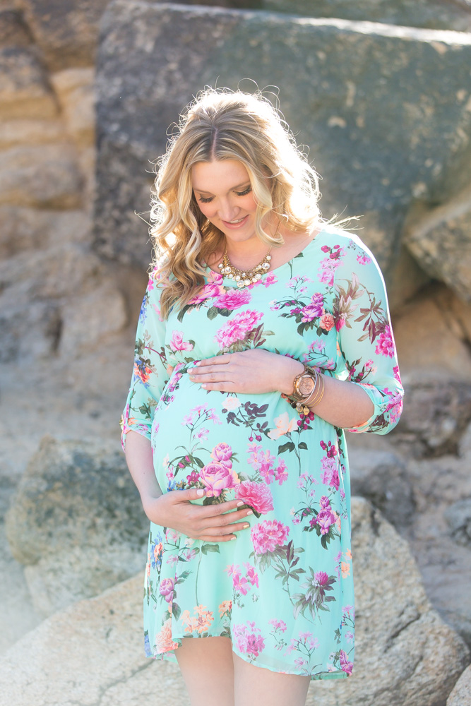 Sunny photograph of beautiful pregnant woman in a sweet spring dress in Lake Tahoe at Sand Harbor by Lake Tahoe Wedding Photographer