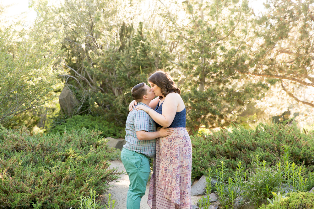 Engagement photo of same-sex couple kissing at beautiful park in Reno by Lake Tahoe Wedding Photographer