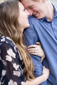 Closeup of engaged couple's ring and smiling faces during their engagement portrait by Lake Tahoe Wedding Photographer