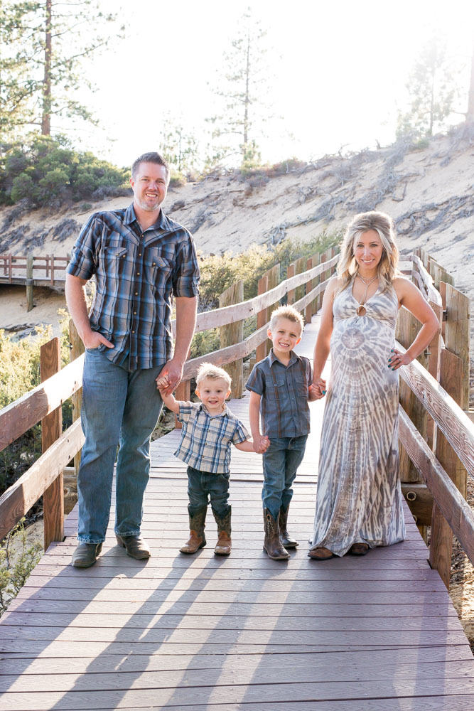 Family standing together on wooden path at Sand Harbor for Lake Tahoe Maternity Photography by Tahoe Maternity Photographer