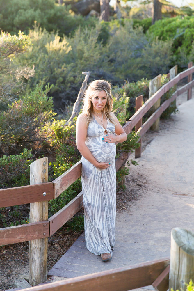 Mother-to-be holds her baby bump at Sand Harbor for Lake Tahoe Maternity Photography by Tahoe Maternity Photographer