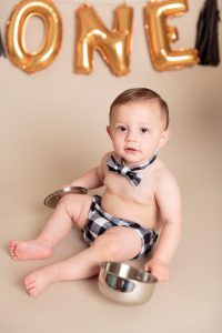 One year old boy plays with pots and pans before his One Year Spaghetti Smash portrait session by Reno Baby Photographer