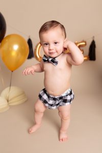 Cute baby boy portrait with black and gold balloons by Reno Baby Photographer