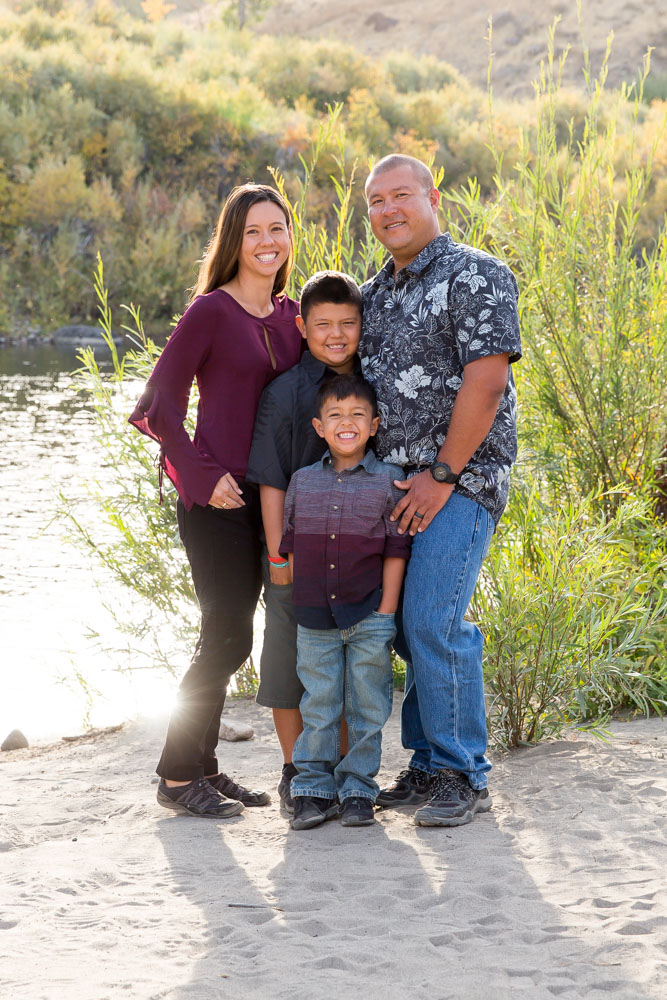 Fall portrait at Mayberry Park of family of four in front of the Truckee River by Reno Family Photographer