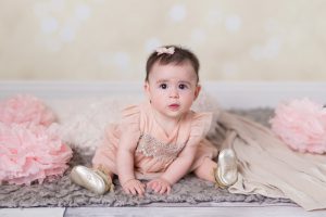 Reno baby photographer of little girl in pink dress