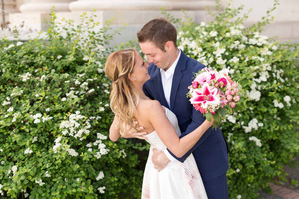 couple embraces for a portrait in front of the old Reno City Courthouse by Reno Wedding Photographer