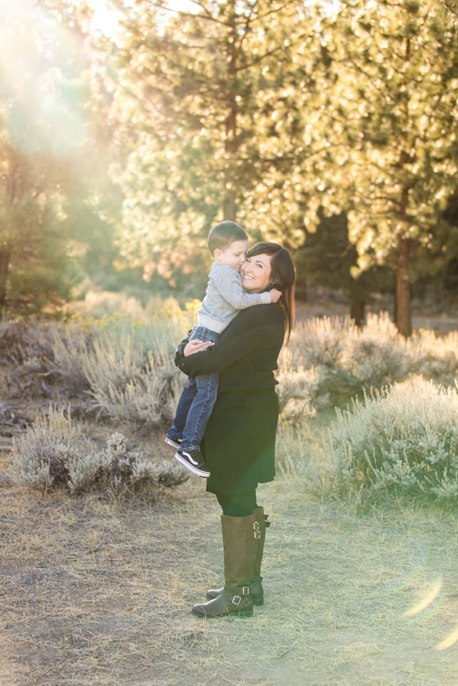A mom holds her son in golden light for their reno fall family portraits