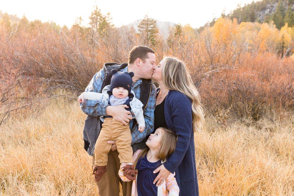 Family of four stands in a golden field in Hope Valley, CA for their family portraits in peak fall season with Hope Valley Family Photographer