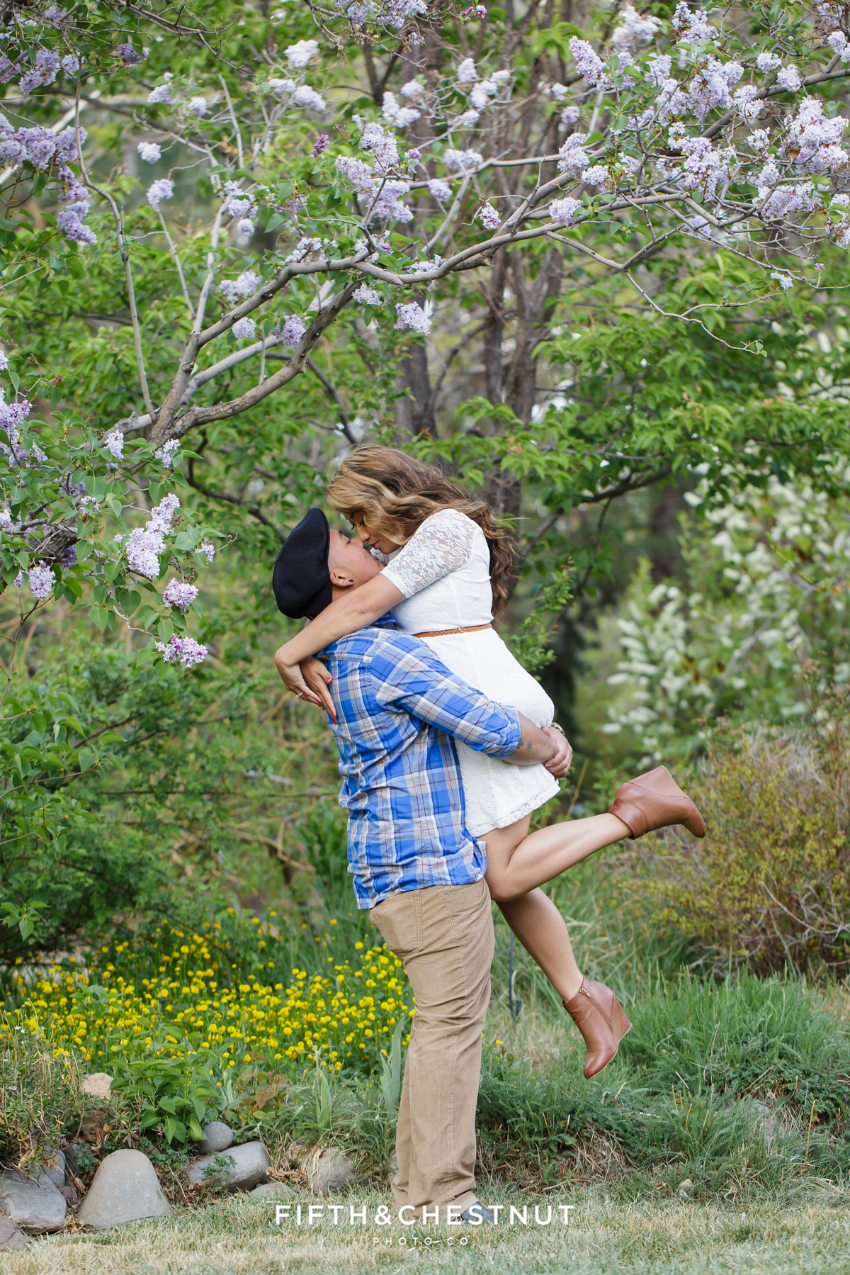 A couple embraces during Reno family photos by Reno Family Photographer surrounded by gorgeous greenery at Rancho San Rafael