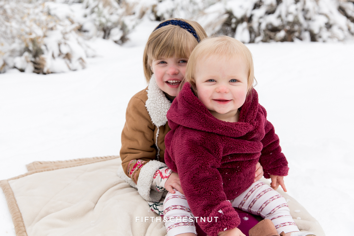 Winter Family Portrait of siblings in snow by Reno Family Photographer