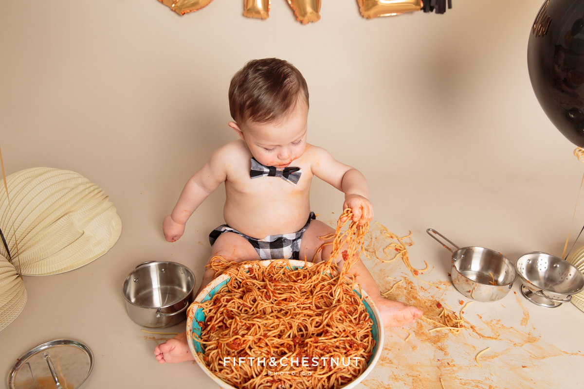 portrait of boy eating spaghetti by reno baby photographer