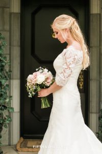 Bride standing in front of a black door at a private estate for a Country French Wedding Styled Shoot in Reno