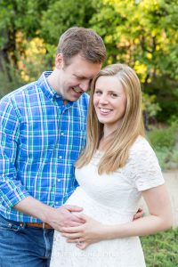 Pregnant woman poses for a picture with her husband for spring reno maternity portraits