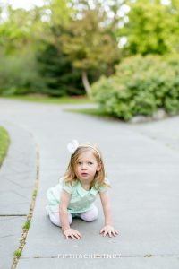 two year old girl pretending to be a frog at Rancho san rafael for reno maternity portraits