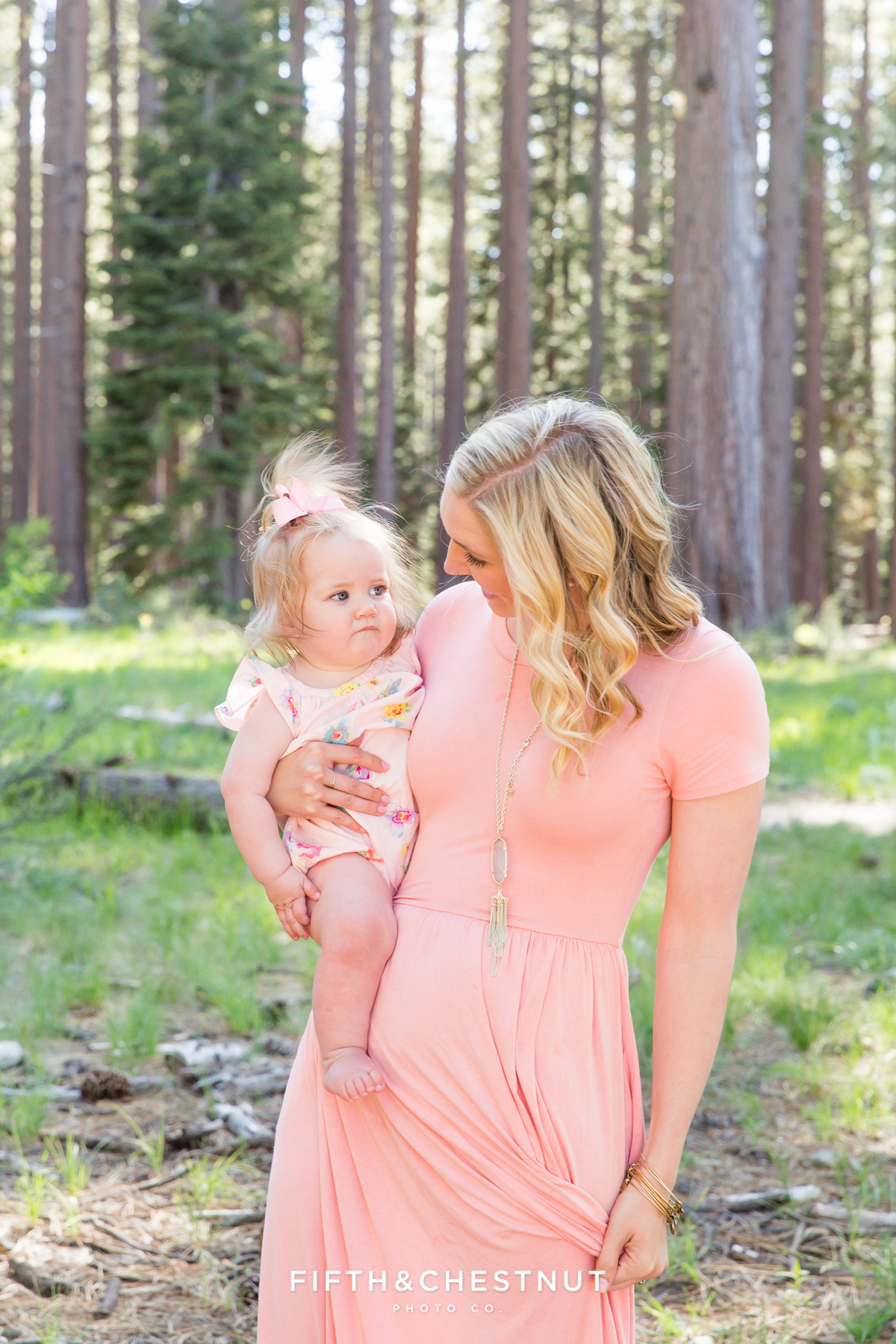 Portrait of a mom and her one year old daughter at Kiva Beach in the wooded area in Spring by Lake Tahoe Family Photographer