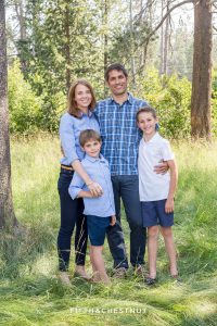 Mom, Dad and two sons stand proudly for a truckee family portrait