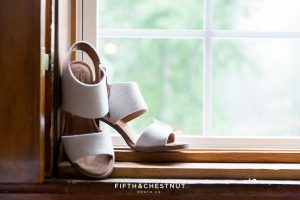 Tom's wedding shoes sit on a windowsill before a Twenty Mile House wedding