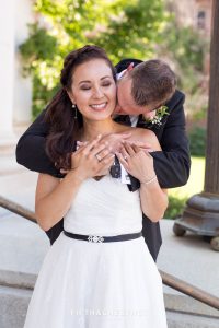 Groom kissing Bride's neck and making her smile