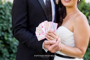 Bride and groom hold playing cards that display their wedding date in Reno