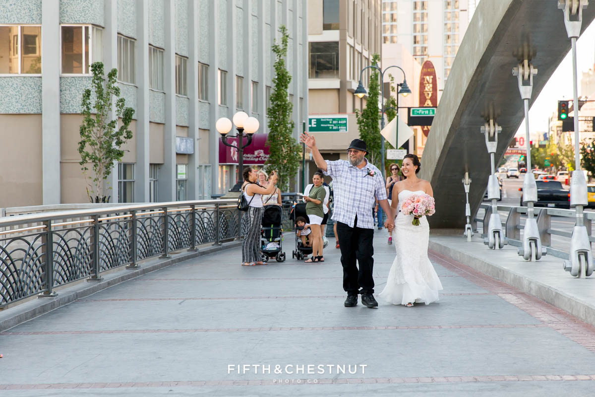 Father of the bride walks his daughter down the Virginia Street bridge for a river ceremony Downtown Reno Elopement
