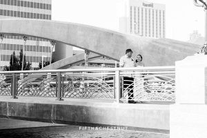black and white image of a father leading his daughter down the virginia street bridge for a Downtown Reno Elopement at the river location of Antique Angel Wedding Chapel