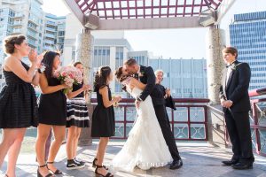 Groom dipping bride during ceremony kiss