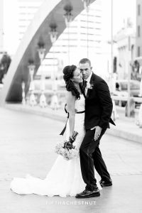 bride and groom being silly together after their Downtown Reno Elopement on the virginia street bridge