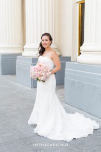 beautiful portrait of the bride at Harrah's in her long wedding gown while holding her pink wedding bouquet