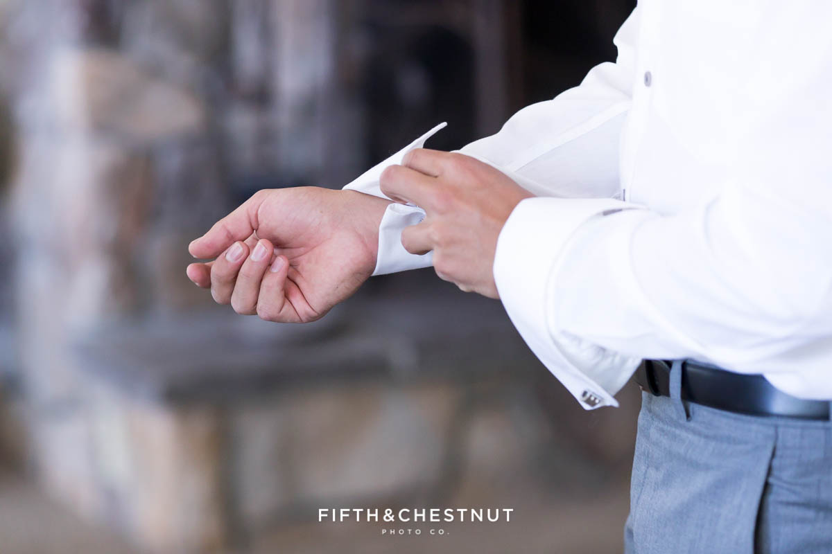Groom buttons up shirt before his North Lake Tahoe Wedding by Lake Tahoe Wedding Photographer