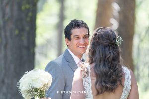 Groom sees his bride for the first time on their wedding day and smiles wildly at her