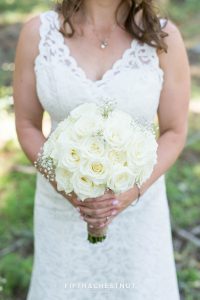 Bride holding wedding bouquet of roses before her North Lake Tahoe Wedding
