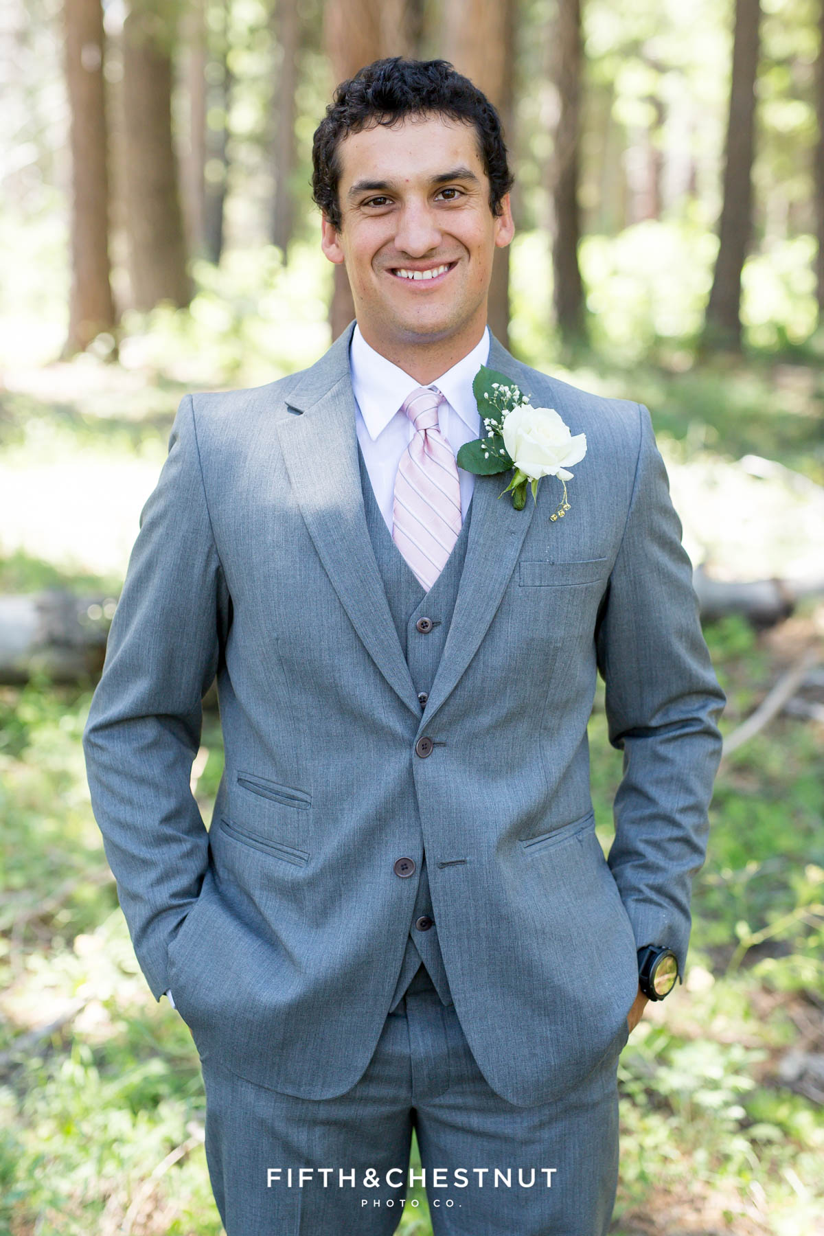Portrait of groom wearing a gray suit and pink tie before his North Lake Tahoe Wedding