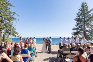 wide shot of lake tahoe wedding ceremony on the beach on a clear beautiful day