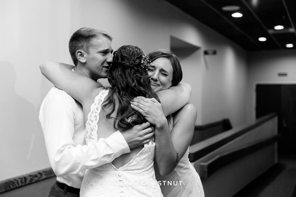 Bride embraces her brother and sister after her wedding ceremony in lake tahoe
