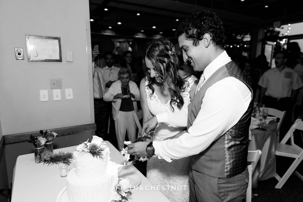 Bride and groom cut the cake at their North Tahoe Event Center Wedding
