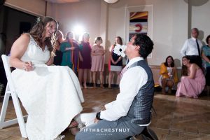Groom gets the garter from under the bride's custom gown made in Ecuador for their North Lake Tahoe Wedding by Lake Tahoe Wedding Photographer