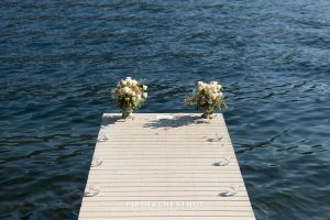 A private dock on Donner Lake decorated with floating candles and floral arrangements for a Donner Lake Proposal