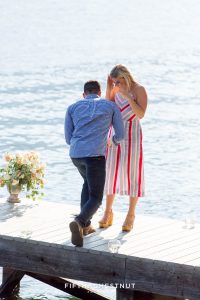 Man gets down on one knee on a private dock for a romantic Donner Lake Proposal