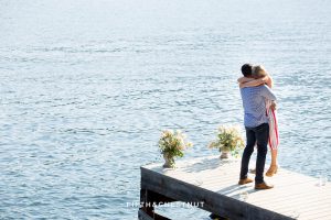 Newly engaged couple embraces on a dock after thier Donner Lake Proposal